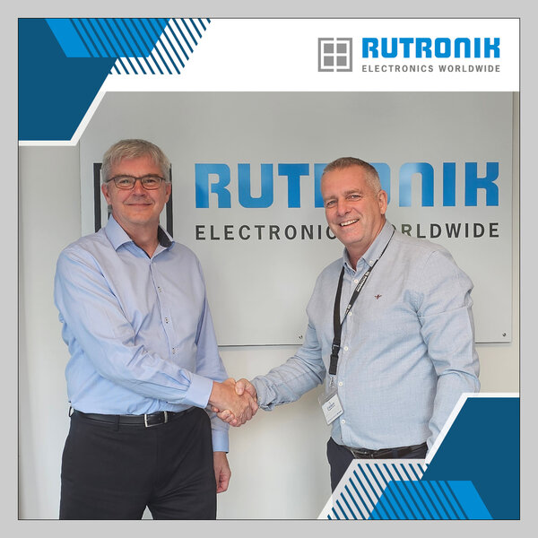 Ron Smith (left) and his successor, Lee Morris (right), shaking hands